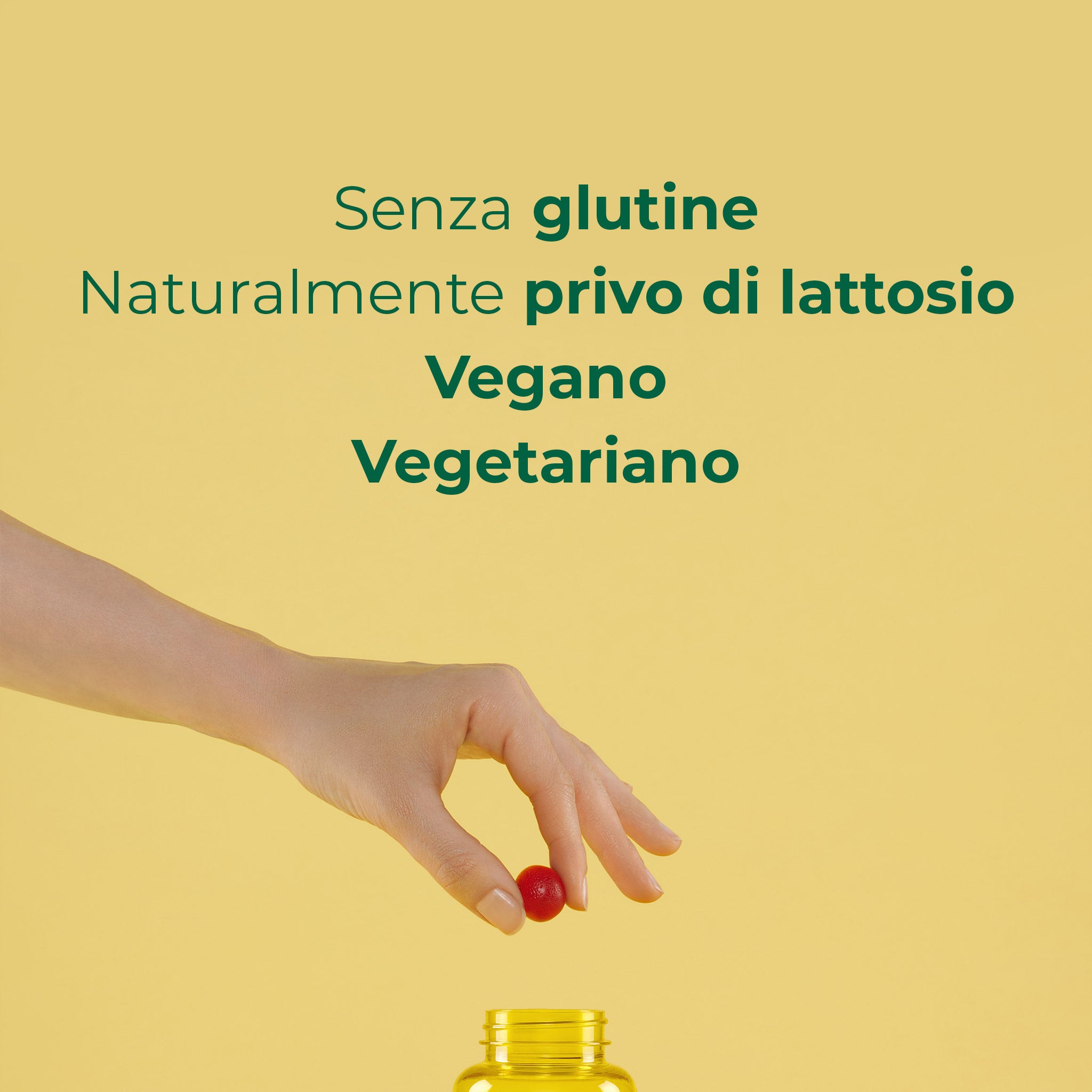 Mano che preleva una gommosa Bioscalin® Stress: integratore vegano, vegetariano, senza glutine e lattosio