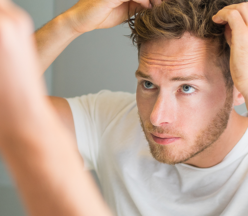 Uomo che applica prodotto Bioscalin® per il cuoio capelluto